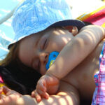 Cute baby sleeping on the beach, Turkey.