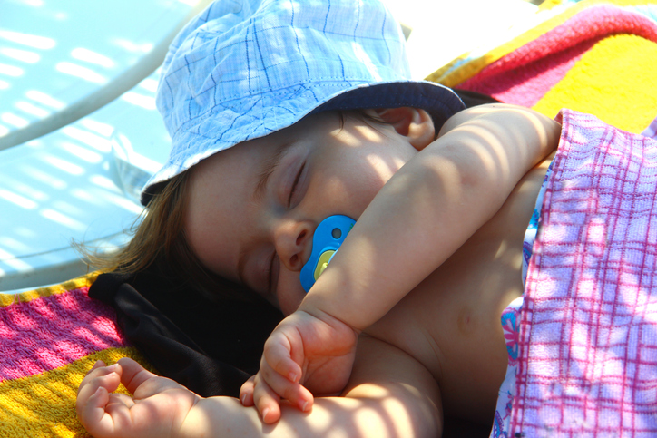 Cute baby sleeping on the beach, Turkey.