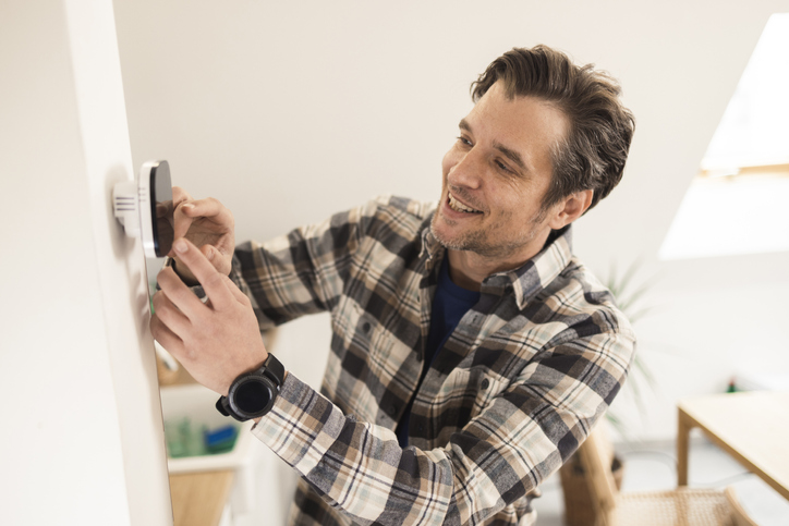 Portrait of a mid adult man setting up the smart home system
