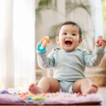 Shot of an adorable baby playing with toys at home