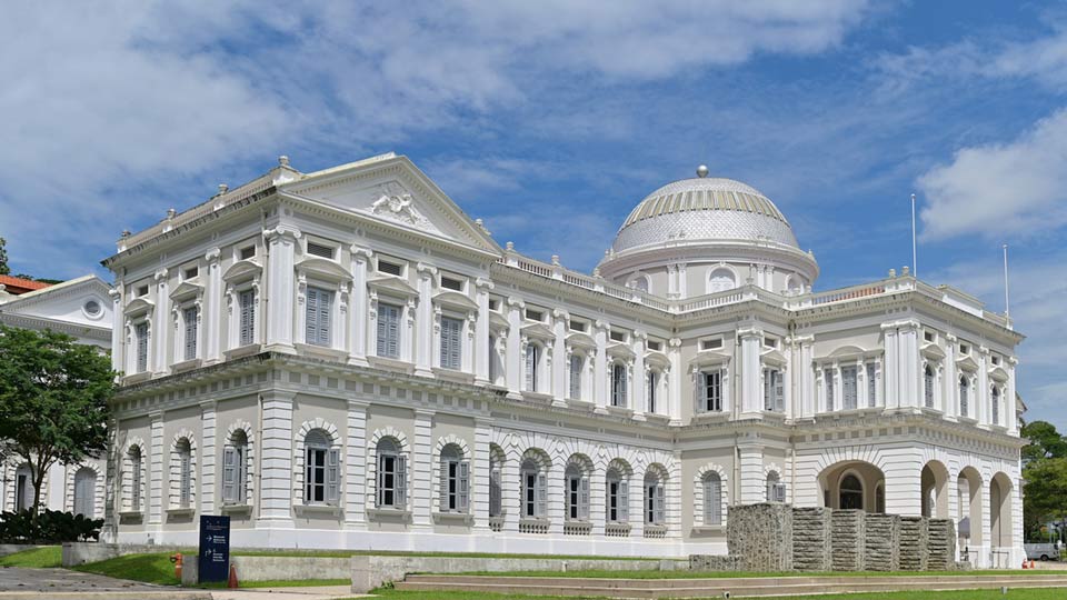 A white building with impressive, traditional architecture host the Singapore Museum